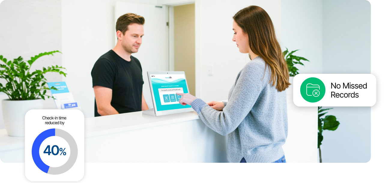 Patient using check-in kiosk with staff member